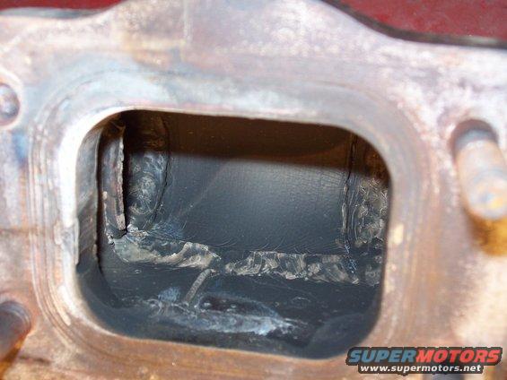 Exhaust manifold port with internal damage and carbon buildup