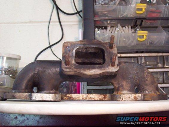 exhaust manifold with rusty bolts and mounting flange