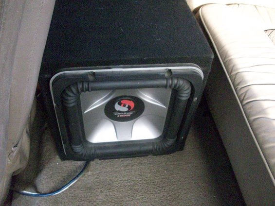 Car subwoofer with Kicker logo inside a vehicle