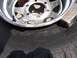 1990 Ford Bronco - A close-up shows a tire and wheel assembly with a sledgehammer nearby.