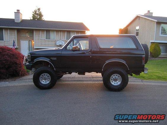Black Ford Bronco parked in front of a house during sunset