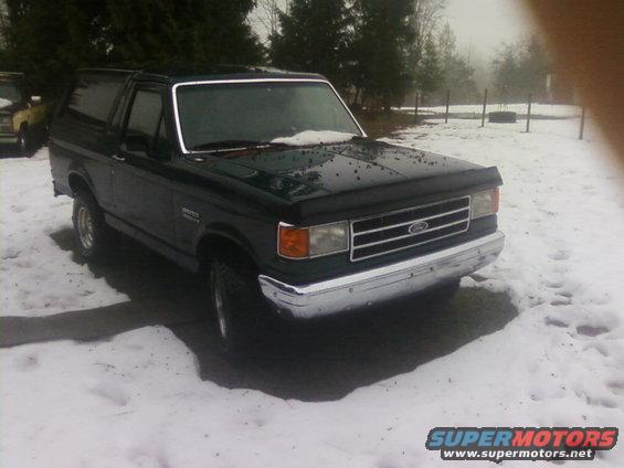 Dark green 1990 Ford Bronco in snow, 3/4 front view