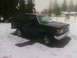 1990 Ford Bronco - A dark green Ford Bronco sits in a snowy yard, its body style indicating a model year around 1987.