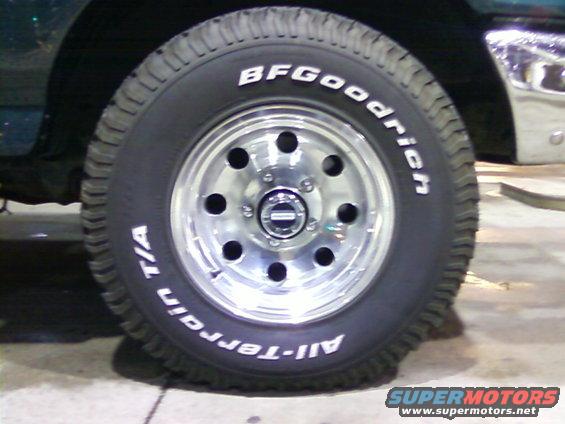 Green vehicle's front wheel with BFGoodrich All-Terrain T/A tires and chrome rim