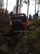 1989 Ford Bronco - A red pickup truck is shown off-roading on a rocky trail with several people observing the action.
