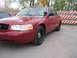 2000 Ford Crown Victoria - Red 2000 Ford Crown Victoria parked on a paved surface, with another vehicle partially visible to the left.