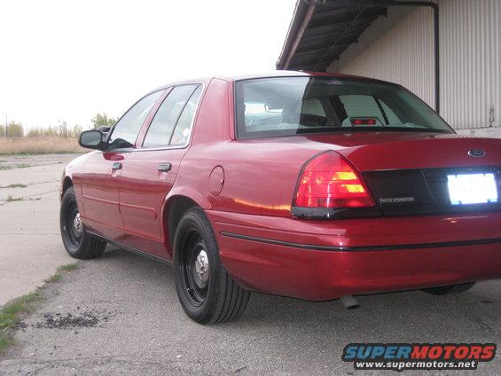 Red 2000 Ford Crown Victoria rear quarter view
