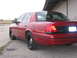 2000 Ford Crown Victoria - Rear quarter view of a red 2000 Ford Crown Victoria, showing its distinctive body style and taillights.
