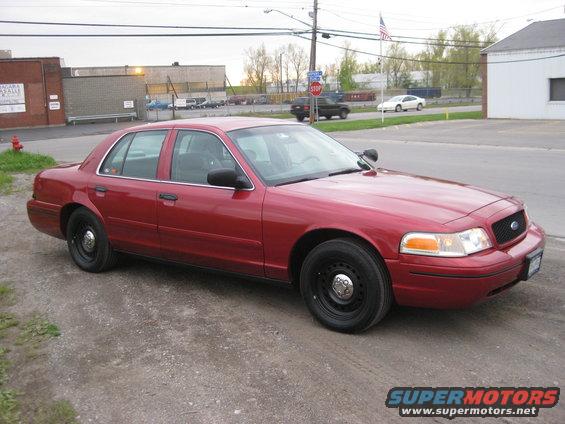 Red 2000 Ford Crown Victoria sedan, front quarter view
