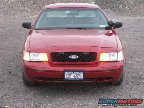 Front view of a red 2000 Ford Crown Victoria police car with New York plates CHY-6896