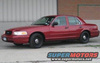 Red 2000 Ford Crown Victoria sedan parked outside