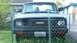 2005 Mazda 6 - Front view of a Mazda truck, partially obscured by a chain-link fence.