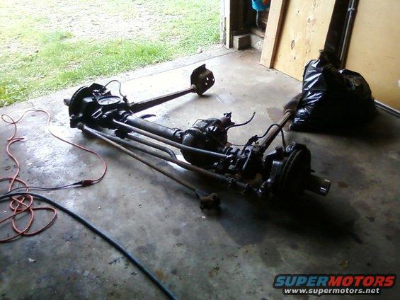 Front axle assembly with brake components and suspension links