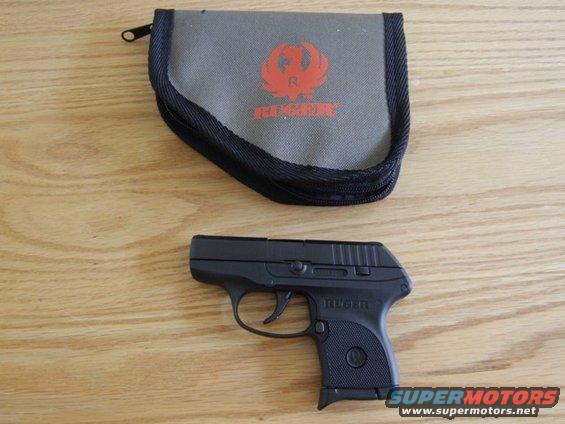 Ruger LCP pistol with its gray zippered case on a wooden surface. The case has the Ruger logo