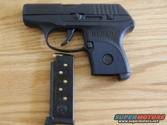 Black Ruger LCP pistol with magazine on wooden surface