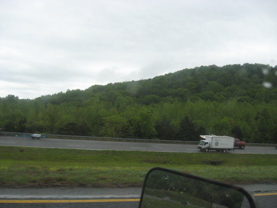 White box truck with GE logo and red pickup truck on highway