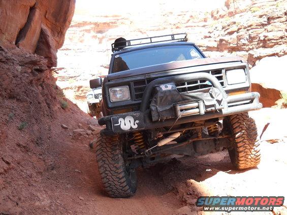 1986 Ford Bronco II navigating a rocky trail with another vehicle behind it