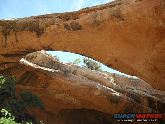 Natural rock arch with blue sky visible through the opening