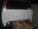 1983 Ford F-250 - Rear view of a truck bed undergoing body work, showing the white painted panels and rusty chassis.