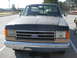 1983 Ford F-250 - This early 1980s Ford F-Series truck features a two-tone paint scheme with a dark blue cab and tan lower body panels.