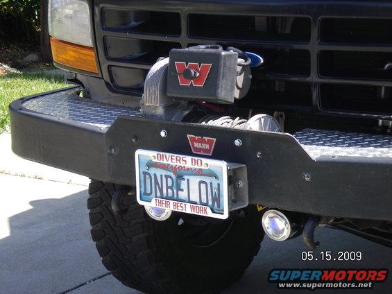 The 8274 is a high power, very fast line speed, winch with 150' of cable and fits perfectly into the area that was designed for it in the Warn bumper. Mounted the license plate with the maglight plastic clamps like Bossind from FSB did and it works like a charm. Push the plate till the clamps click onto the roller fairlead, pull to remove! That's why the extra bolts are drilled into the plate by the letter "D" & "W" to mount the clamps. I've got an older gentleman, on Craig'sList fabbing up a metal solenoid cover to replace the plastic one like he did for his 8274...