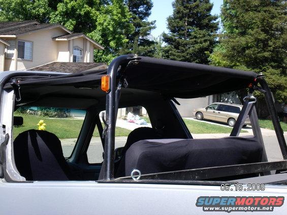 recent-pics-with-new-front-bumper-winch-tires--rims-014.jpg The rear of the soft top is velcro'd and wrapped 360 deg around the show bar I just picked up. I used eye hole bolts to mount the front to give me extra anchor points for cargo, the dog, etc. An extra huge bonus is the KC light mounting tabs work flawlessly as an anchor point for the retractor seatbelts for the kids belts giving them full use of the rear belts again and making me feel much safer about them being in the back!