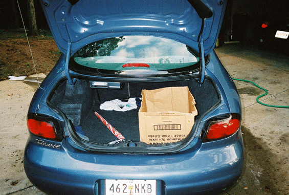 1999 Ford Taurus rear view, trunk open with items inside
