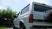 1996 Ford Bronco - Rear view of a white 1996 Ford Bronco parked outdoors on a sunny day.