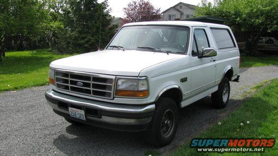 White 1996 Ford Bronco parked on gravel driveway
