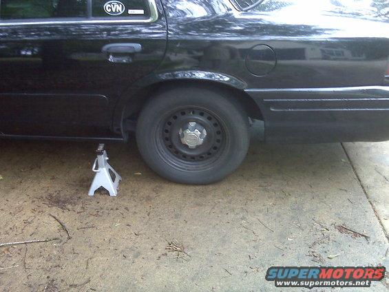 2001 Ford Crown Victoria rear wheel on jack stand, CVN sticker on window
