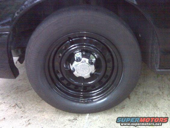 Black steel wheel with a chrome hubcap on a black vehicle
