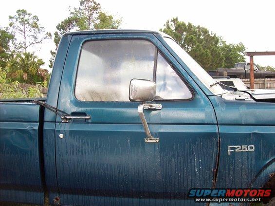Side view of a teal 1987-1991 Ford F-250 pickup truck, showing the driver's door and F250 badge