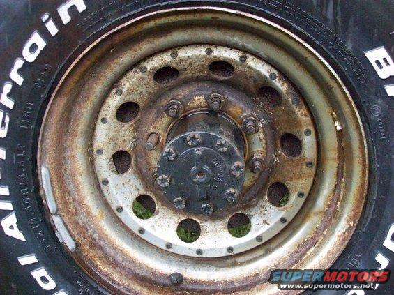 Close-up of a rusty truck wheel hub with a BFGoodrich All-Terrain tire
