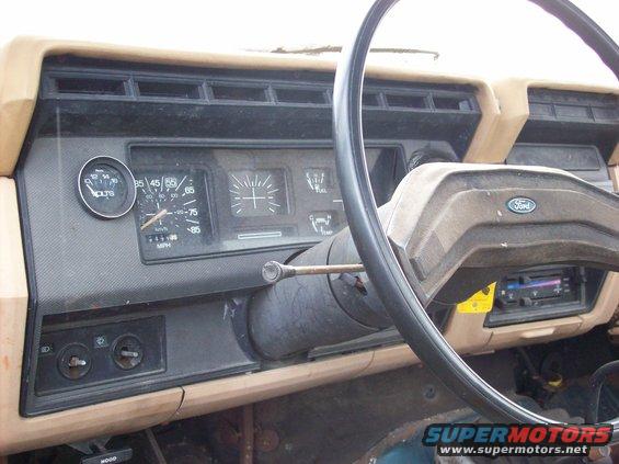 Interior dashboard of a 1985 Ford F-250 showing gauges, steering wheel, and Ford logo