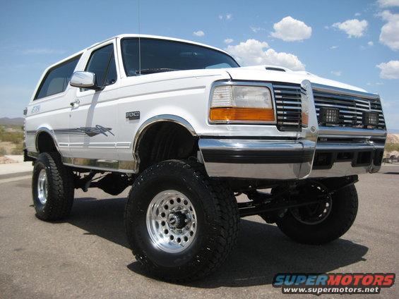 White 1996 Ford Bronco with lifted suspension and chrome wheels