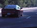 1989 Nissan 300ZX - A red Ford Probe is seen driving on a highway, captured from behind.