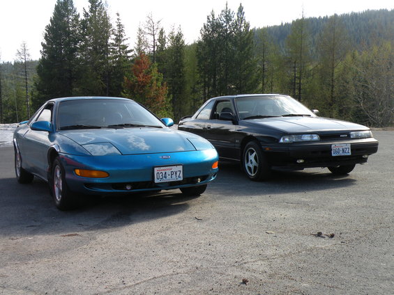 Blue Ford Probe and black Mazda 626 parked side-by-side