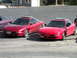 1989 Nissan 300ZX - Two red Ford Probes are parked side-by-side in a paved area, with a purple car partially visible to the left.