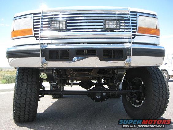 Front view of a lifted 1992 Ford F-Series truck with a chrome grille and aftermarket lights