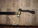 1987 Suzuki Samurai - Steering linkage part shown against a brick background.