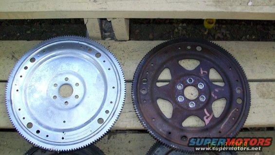 Two metal flexplates, one shiny and one rusty, with visible bolt holes and teeth