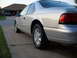 1995 Ford Thunderbird - A silver 1995 Ford Thunderbird is parked in a driveway with a garage in the background.
