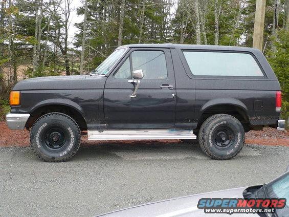 1987 Ford Bronco side profile, dark gray paint, aftermarket wheels