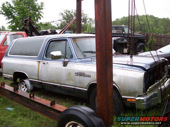 Two-tone 1988 Dodge Power Ram Ramcharger SUV, front quarter view, being lifted