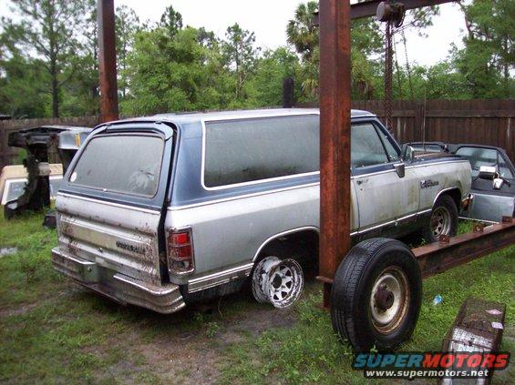 1988 Dodge Ramcharger SUV, rear view, missing one wheel, parked outside