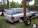 1988 Dodge Power Ram - Rear view of a 1988 Dodge Ramcharger SUV in an outdoor setting, missing a wheel.