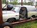 1988 Dodge Power Ram - A weathered Dodge Ramcharger sits on a trailer, its interior exposed to the elements.