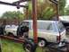 1988 Dodge Power Ram - This 1988 Dodge Power Ram SUV is on a trailer, suspended by a hoist, with a second vehicle visible in the background.