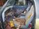 1988 Dodge Power Ram - Interior view of a 1988 Dodge Power Ram showing worn seats and a disassembled dashboard.