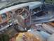 1988 Dodge Power Ram - The interior of this 1988 Dodge Power Ram shows a worn dashboard and steering wheel, with debris scattered on the floor.